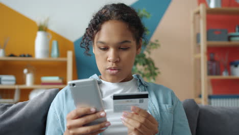 teenager using mobile phone and credit card for online shopping