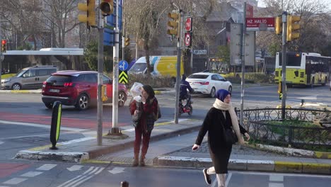 people crossing a busy street in a turkish city