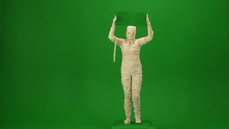 green screen isolated chroma key video capturing a mummy dancing and singing actively into the - green screen isolated chroma key video capturing a mummy dancing and singing actively into the microphone. haloween holidays. mock up, workspace for your promotion clip or advertisement
