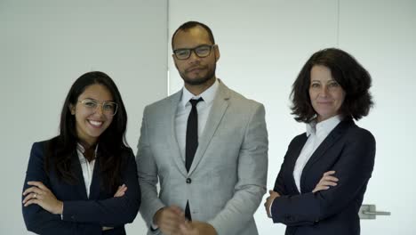 Confident-young-people-wearing-suits-posing-in-office