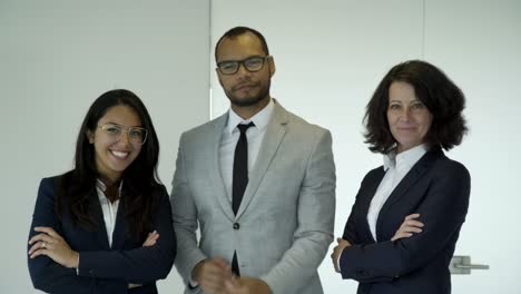 confident young people wearing suits posing in office