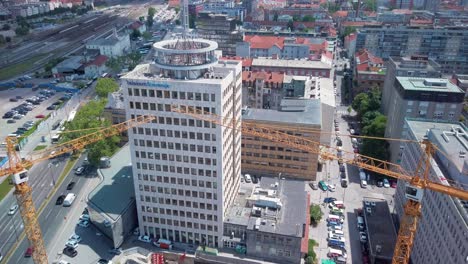 hotel construction site in ljubljana, slovenia. new luxury hotel built next to the railway station in the background.