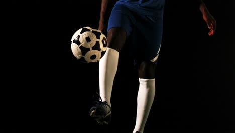 Football-player-in-blue-controlling-the-ball