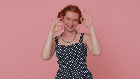 happy young woman looking approvingly showing ok gesture, like sign positive, approve something good