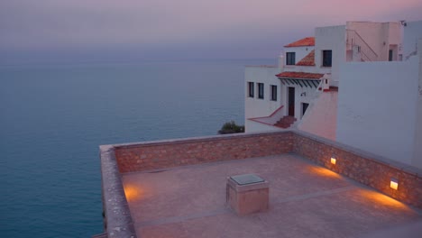 high angle shot over peniscola roof with the view of sea and horizon in background in castellon, spain during evening time