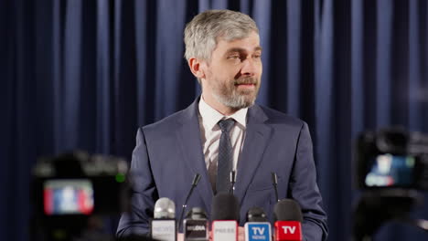 mid-aged politician holding speech at press conference