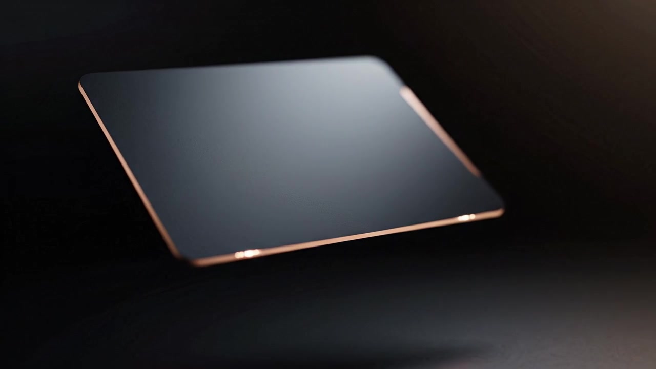 A sleek, modern technological device levitating against a dark backdrop, showcasing its thin design and polished surface, embodying innovation and elegance.