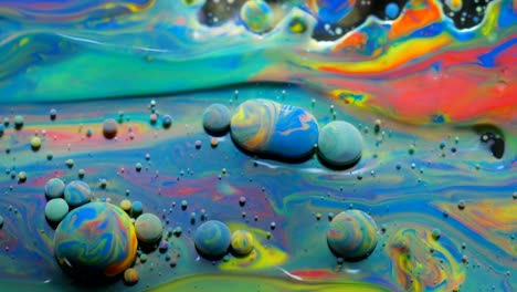 slow motion bright colors bubbles oil beautiful paint universe color moving multicolored closeup. acrylic paint. fantastic surface. abstract colorful paint metamorphosis structure colorful bubbles