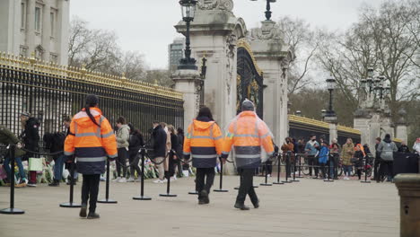 Stewards organising the laying of flowers in tribute of Prince Philip outside Buckingham Palace