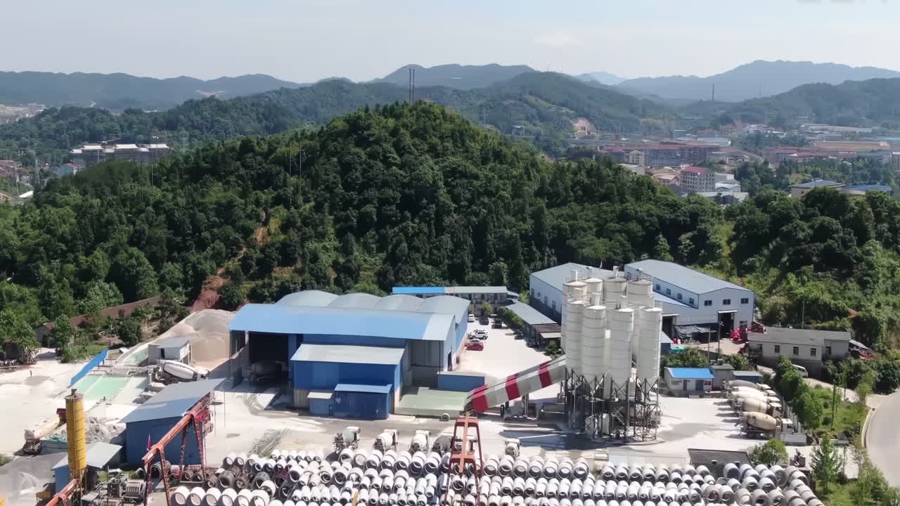 Cement plant high factory structure and tower crane with high concrete plant structure at industrial production area. Manufacturing and global industry concept.