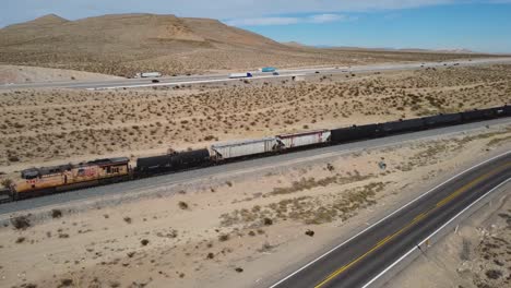 aerial view over nevada desert landscape with freeways and train railroad