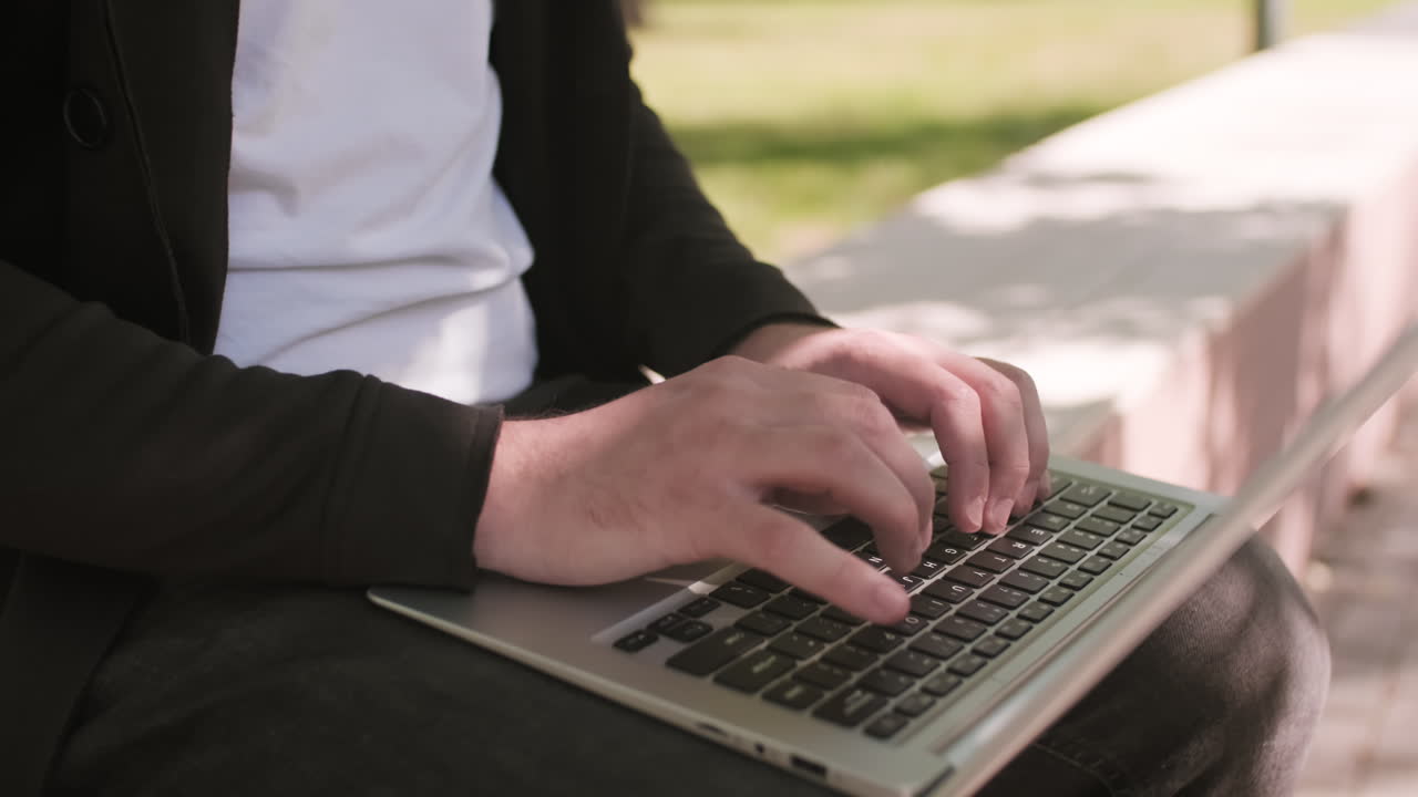 Close Up of Male Hands Working on Laptop