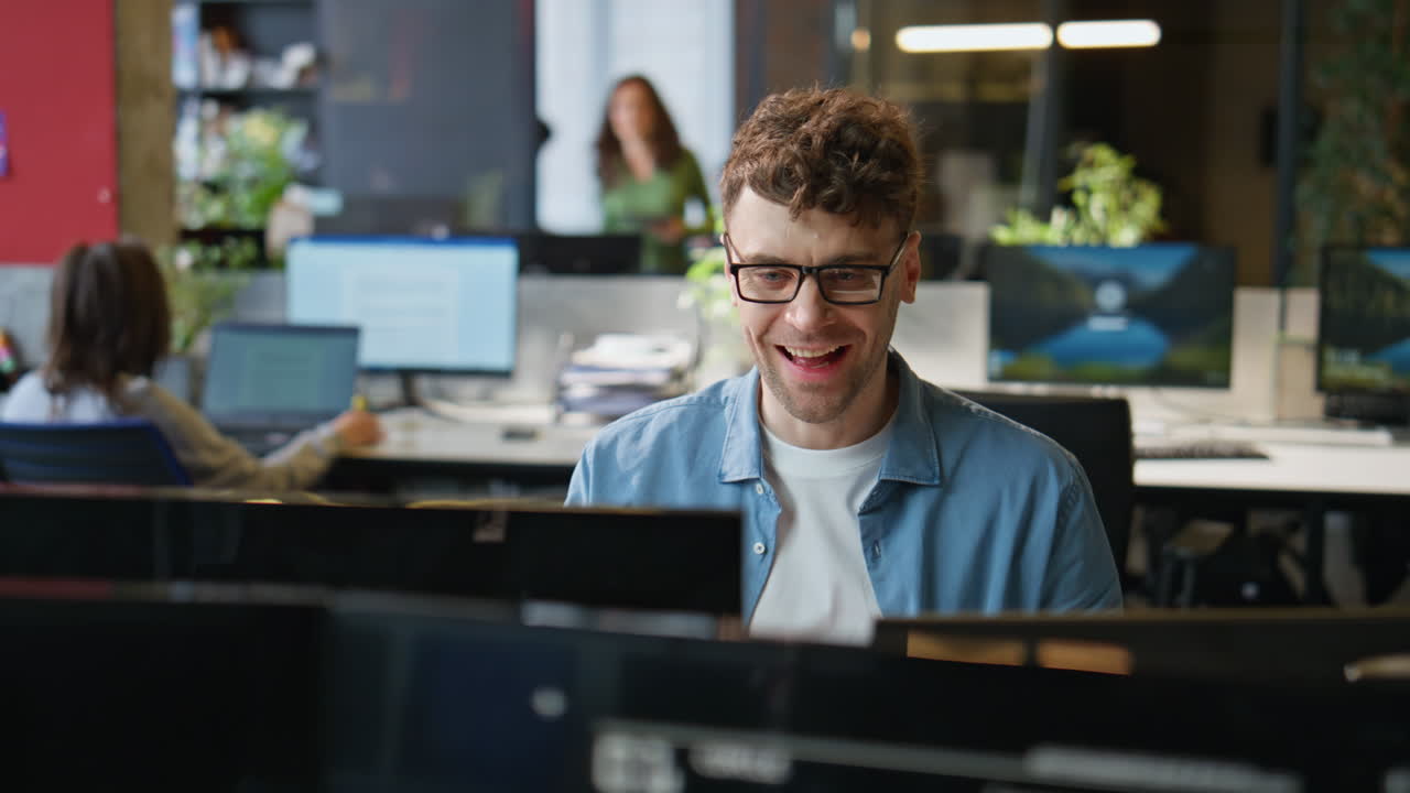 Smiling programmer typing keyboard working computer at office workplace closeup