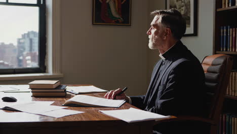 priest studying in office