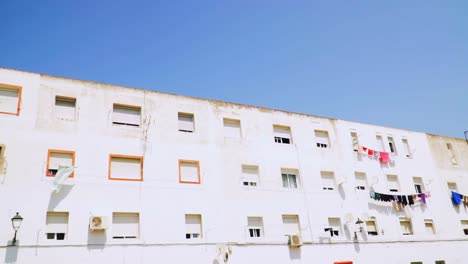 Clothes-Hanging-from-Clothesline-Against-apartment-building