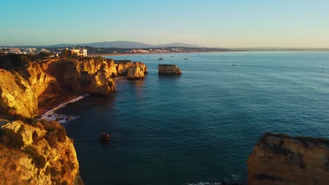 aerial jib up revealing amazing cliff sides painted with golden hour sun