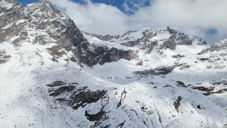 Fly-Over-Majestic-Mountain-Peaks-in-the-Alps-from-a-Drone-in-Winter-on-a-sunny-day