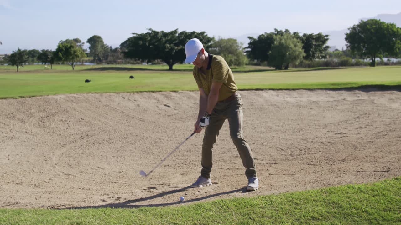 골프 선수 가 클럽 으로 공 을 치고 있다