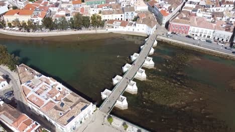 Circling-Shot-of-The-Ponte-Romana-Bridge-on-the-river-Gala-Tavira-Algarve-Portugal,-a-traditional-old-town-on-the-edge-of-the-Atlantic-sea