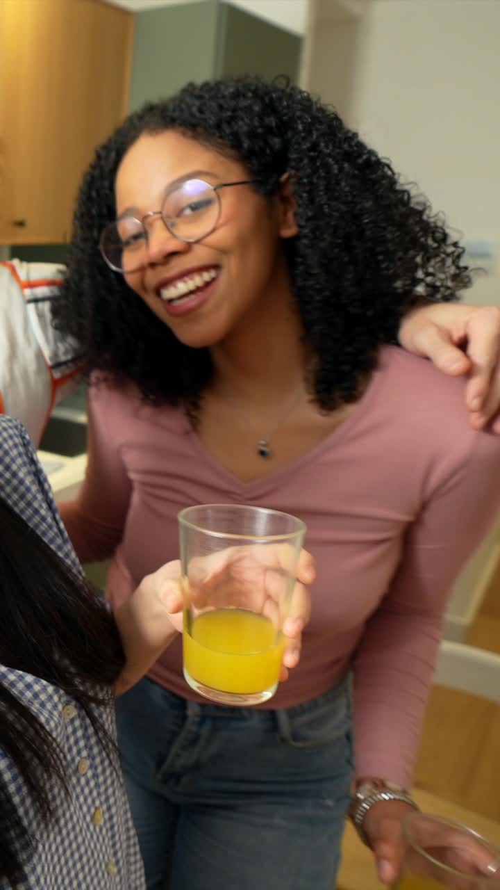 Friends celebrating together with orange juice