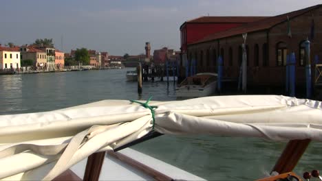 boat sails into venice, italy