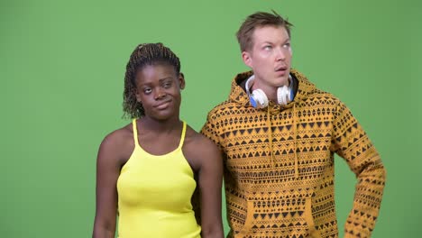 young multi-ethnic couple looking bored together