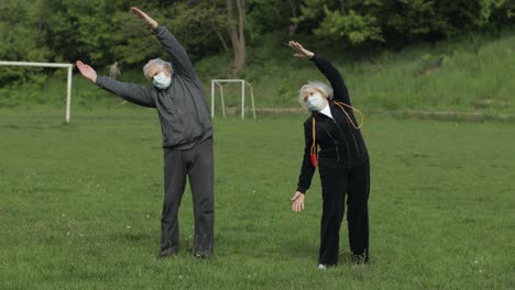 Active-senior-old-couple.-Man-and-woman-do-stretching-physical-exercises