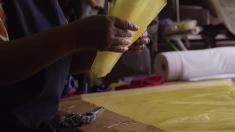 mixed race woman working at a hat factory