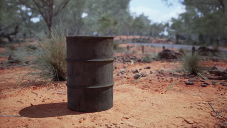 old empty rusted barrel on sand