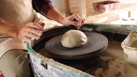 mid section of potter making pot