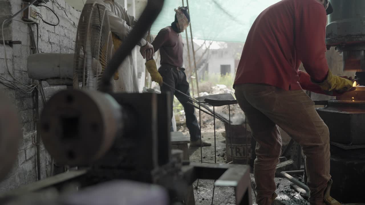 Ironworkers Forging Metal In A Manufacturing Workshop In Pakistan