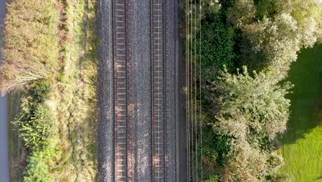 Aerial-Bird's-Eye-View-of-train-tracks-during-the-day-in-Sweden