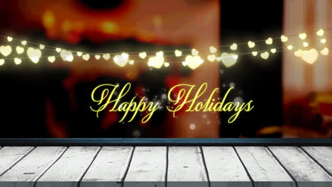 Animation-of-fairy-lights-and-happy-holidays-text-over-wooden-boards