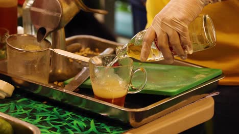 pouring and mixing ingredients for a beverage