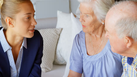 front view of senior caucasian couple meeting with real estate agent in a comfortable home 4k