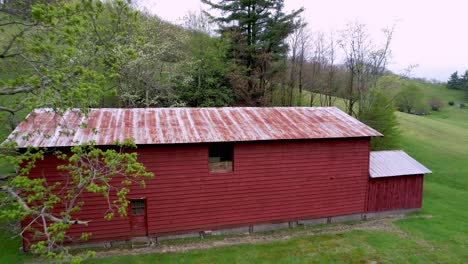 aerial pullout from red barn on farm near boone and blowing rock nc, north carolina