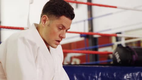 man taking rest after practicing karate