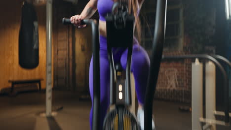 close up of an attractive confident girl doing elliptical in the gym