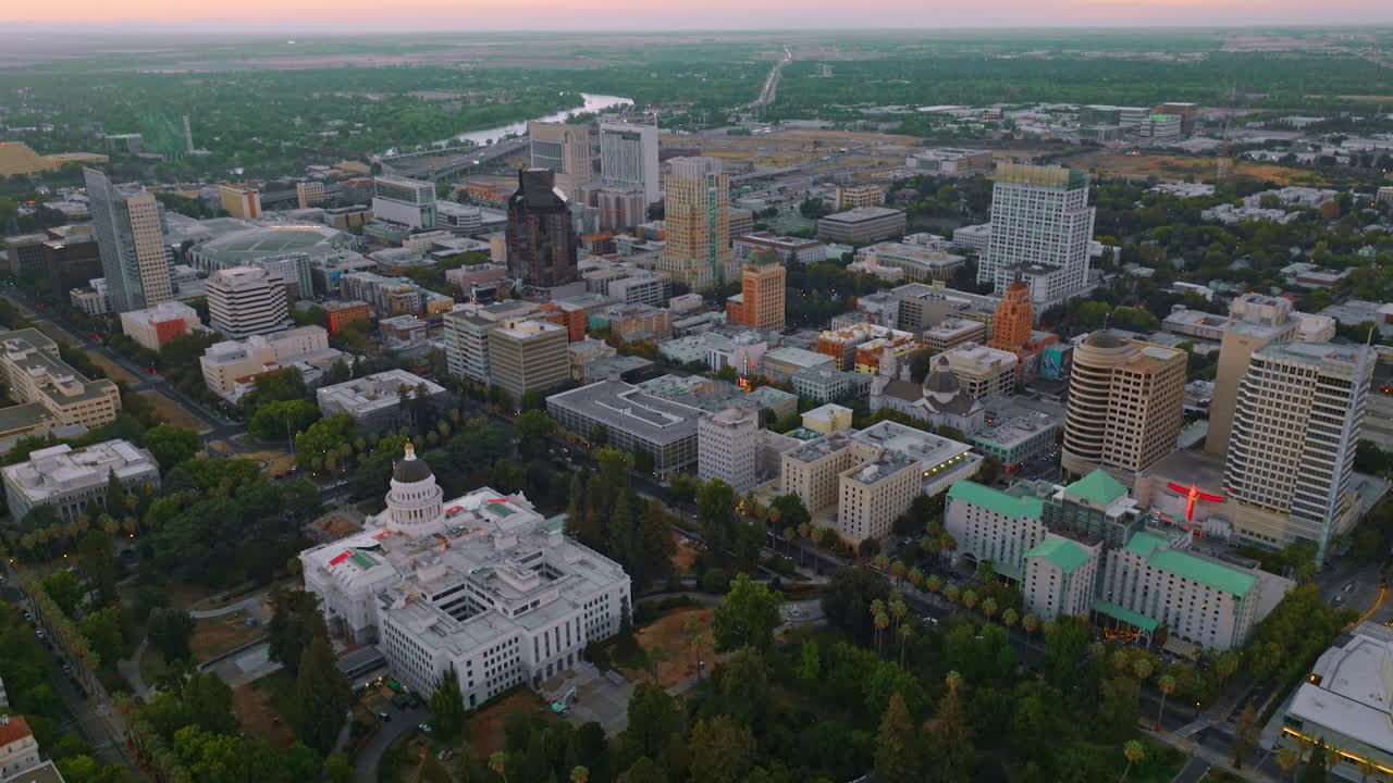 Modern architecture of Sacramento downtown in the evening. River and green landscape at backdrop. Top view.