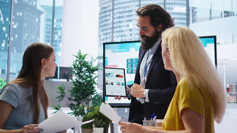broker showing stock exchange charts on tablet to parent and girl