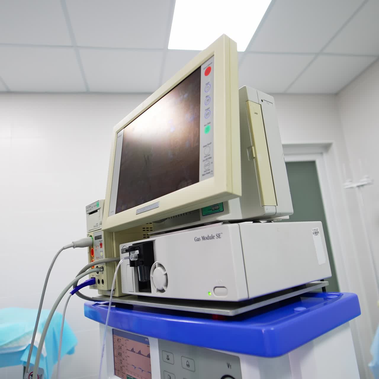Special equipment in surgery room for control of patient's vital signs. Black screen showing numbers. Low angle view