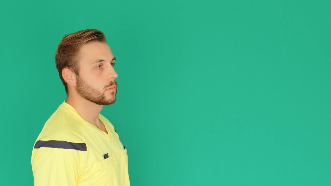 Football Soccer referee on green screen shows penalty red card, 4k