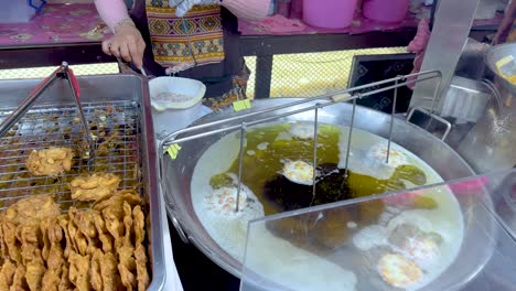 peanuts frying in a pan at floating market