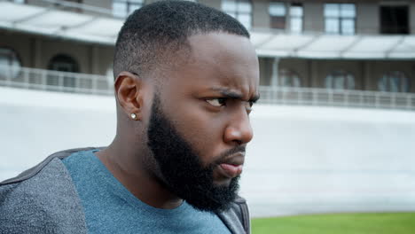 serious guy looking away outdoors