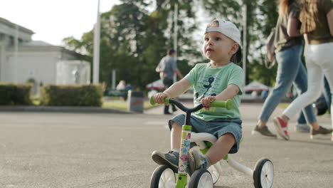 Little-child-riding-his-cycle-outdoors.