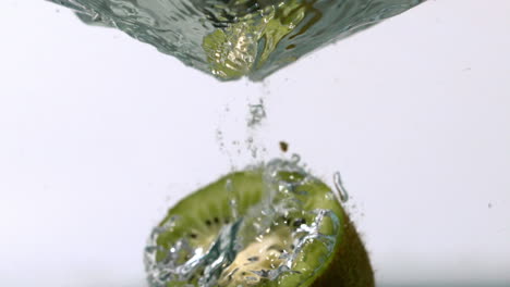 kiwi half falling into water