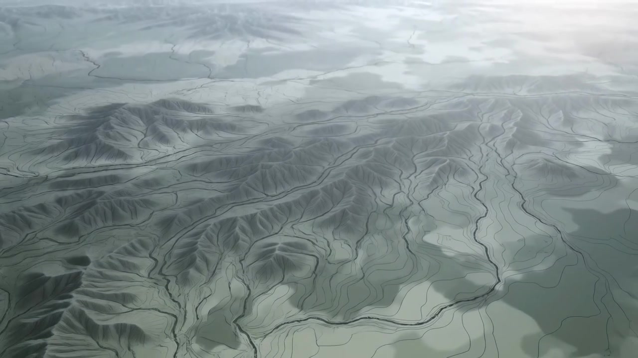 Aerial middle-sequence pan over eroded ridge and winding dry riverbeds revealing layered terraces