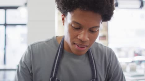 Animation-of-happy-biracial-waiter-using-meat-cutting-machine