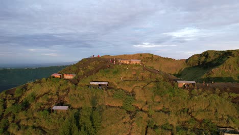 aerial dolly zoom out of coffee huts on a volcano rim in bali indonesia