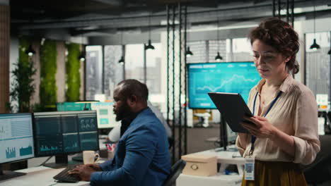 vertical video woman business consultant examines charts and icons on tablet
